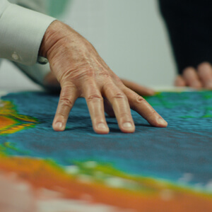 Hand pointing to points on a map