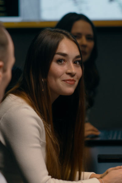 Smiling female employee in a meeting