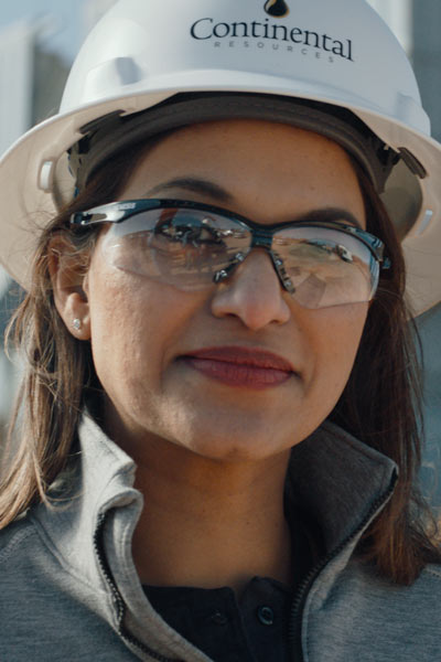 Female worker in hard hat and goggles